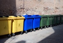 three type of plastic big trash recycling bins on the street