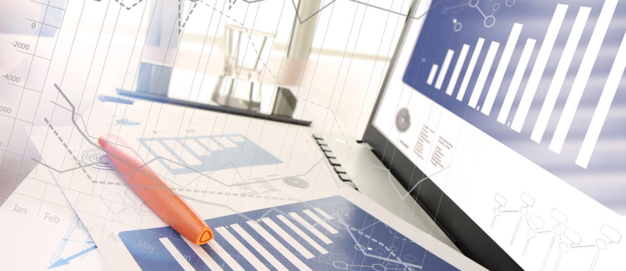 business documents on office table with smart phone and digital tablet and modern pen with laptop computer in workspace concept
