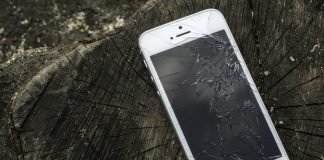 Broken white iphone glass on wood