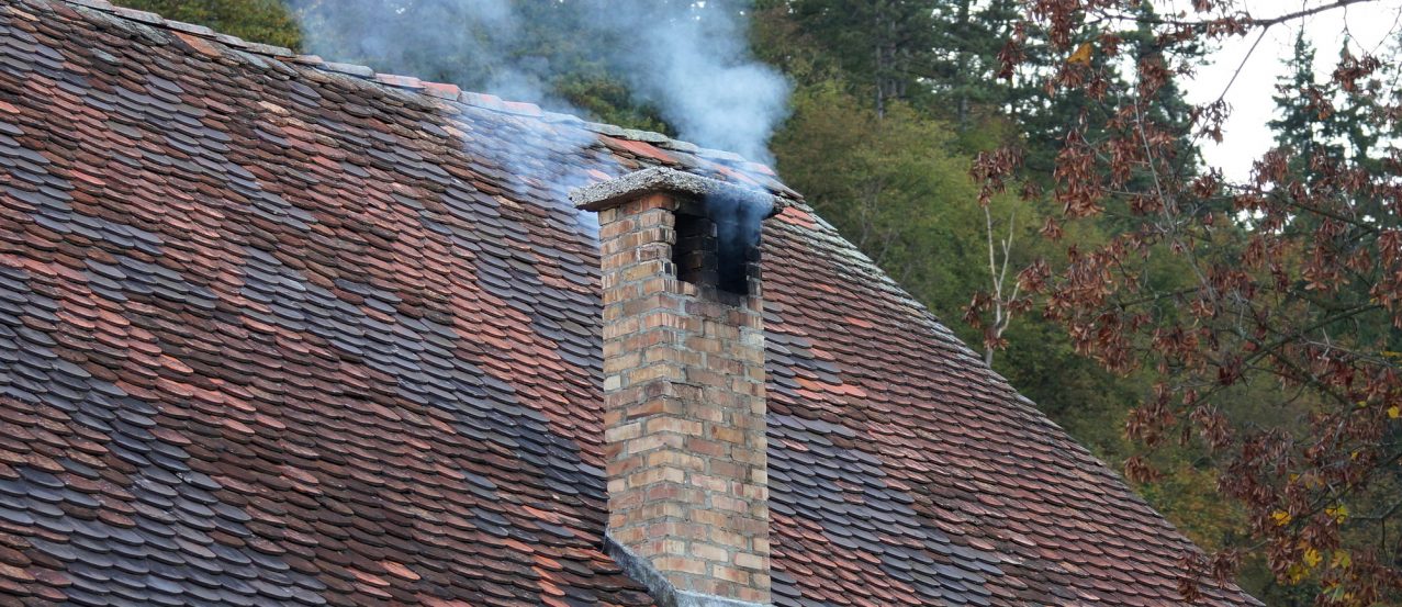 smoke from the chimney of the old house