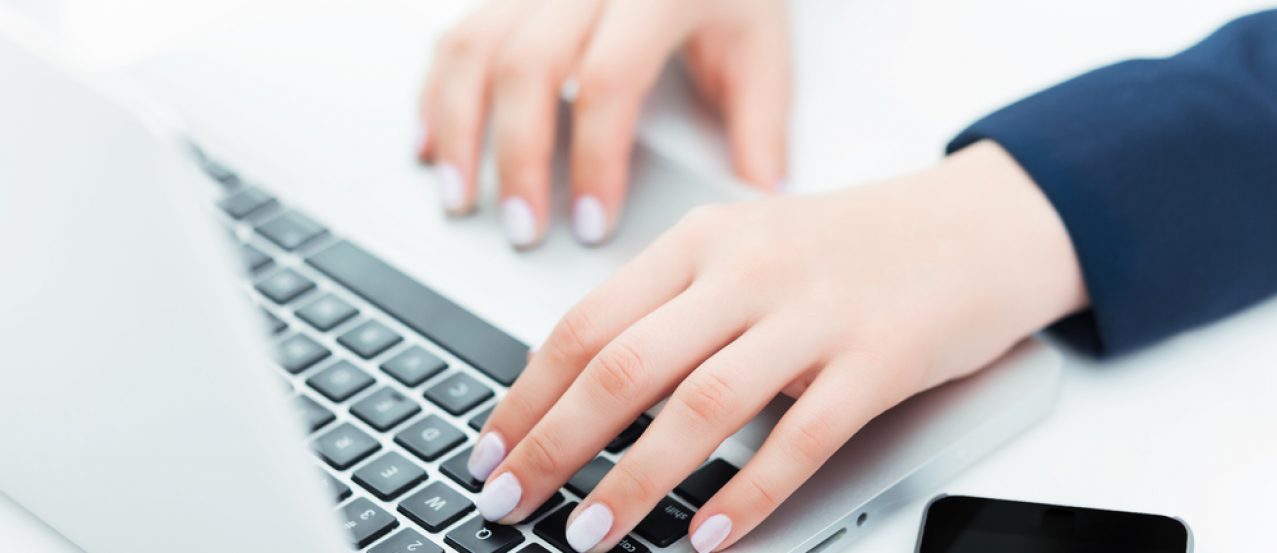 The hands of woman on the keyboard of her laptop computer