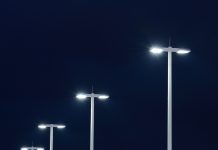Mroczne początki oświetlenia ulicznego Modern street lights illuminated at night against a dark sky