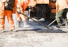 Wydatki na drogi w latach 2015-2020 builders at Asphalting paver machine during Road street repairing works