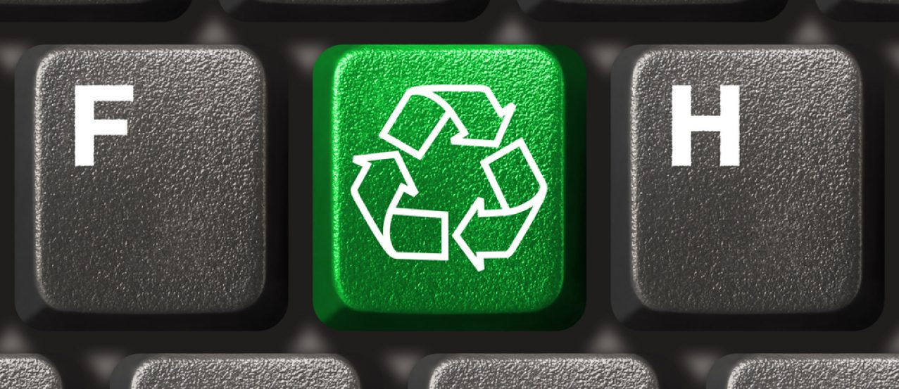 Computer keyboard with recycling symbol, technology concept