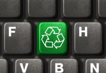 Computer keyboard with recycling symbol, technology concept