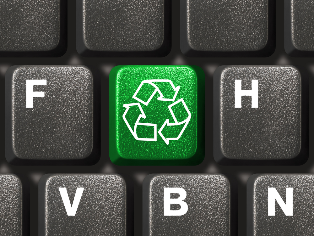 Computer keyboard with recycling symbol, technology concept