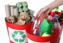 Putting empty bottles into recycling bins, closeup