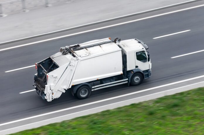 Recycling truck rides on the road in the city. Recycling truck rides on the road in the city